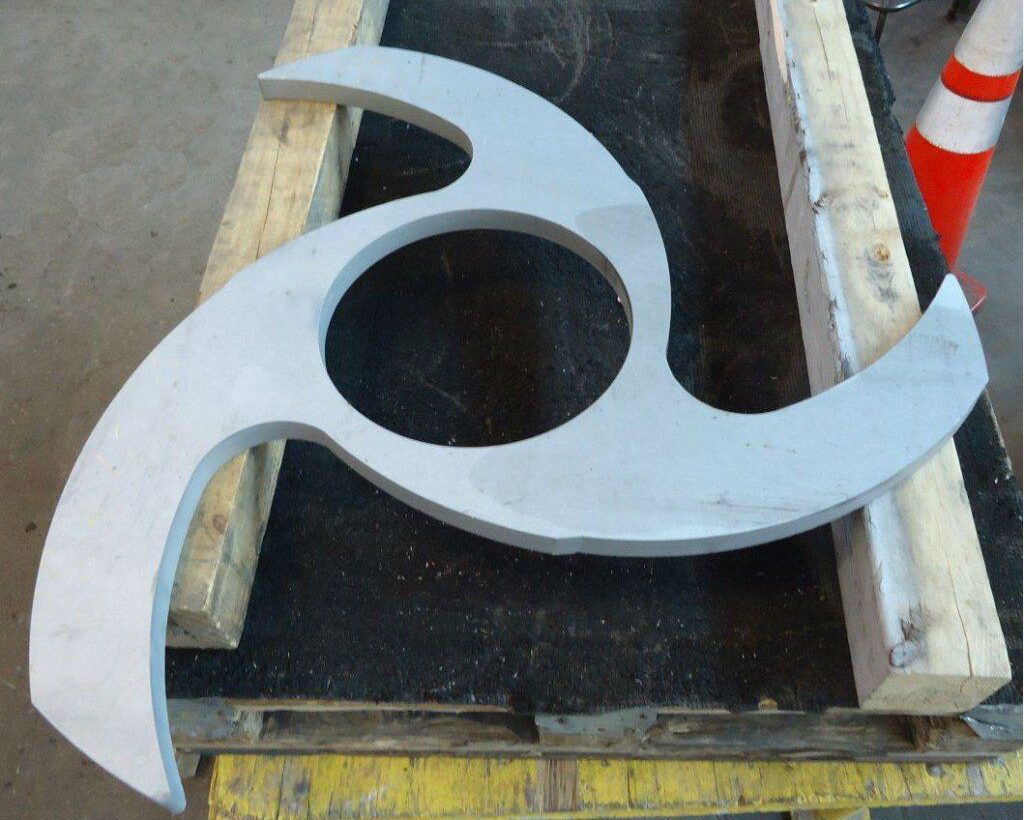 Specialty-cut stainless steel component made from 1” thick 2304, produced for a pulp and paper equipment manufacturer. The piece, cut with precision using a waterjet machining center, features a unique curved design.