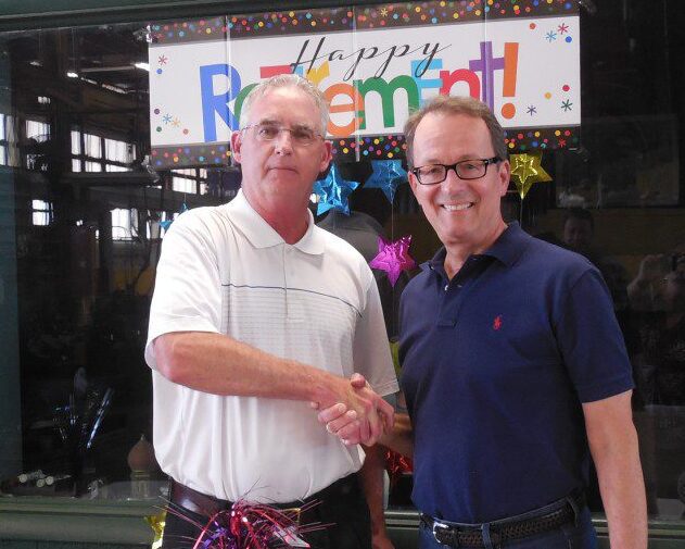 Jack McConnell and Ronald P. Sandmeyer, Jr. shaking hands at Jack's retirement celebration.