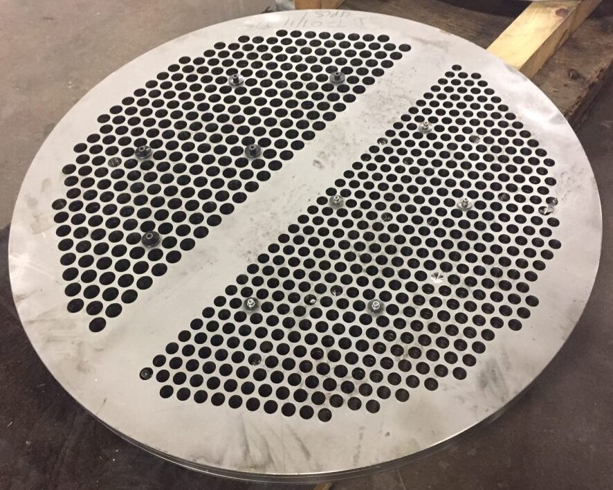 1/2” thick 304 stainless steel heat exchanger baffles with precision-drilled 5/8” diameter holes, produced on Sandmeyer Steel’s Quickmill Annihilator.