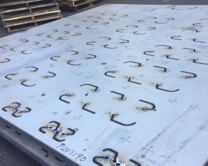 Two custom-cut pieces of 1 1/2” thick 304 stainless steel, precisely cut to customer specifications.