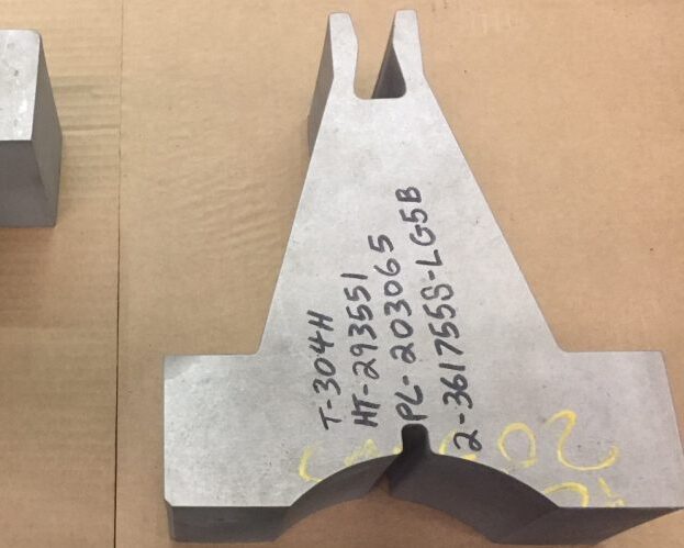 Custom 4” thick 304H stainless steel parts, produced by Sandmeyer Steel for a customer specializing in industrial pipe support systems using a waterjet machining center.