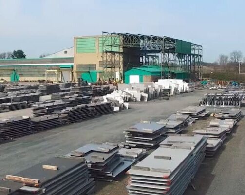 An aerial view of Sandmeyer Steel’s outdoor inventory area, showing stacks of stainless steel and nickel alloy plates. The facility is equipped for handling large quantities of metal products, including Nickel Alloy Plate SSC Invar 36 in various thicknesses.