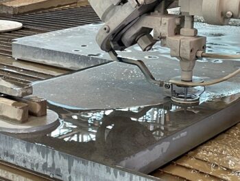 Waterjet cutting thick stainless steel plate into a near-net shape.